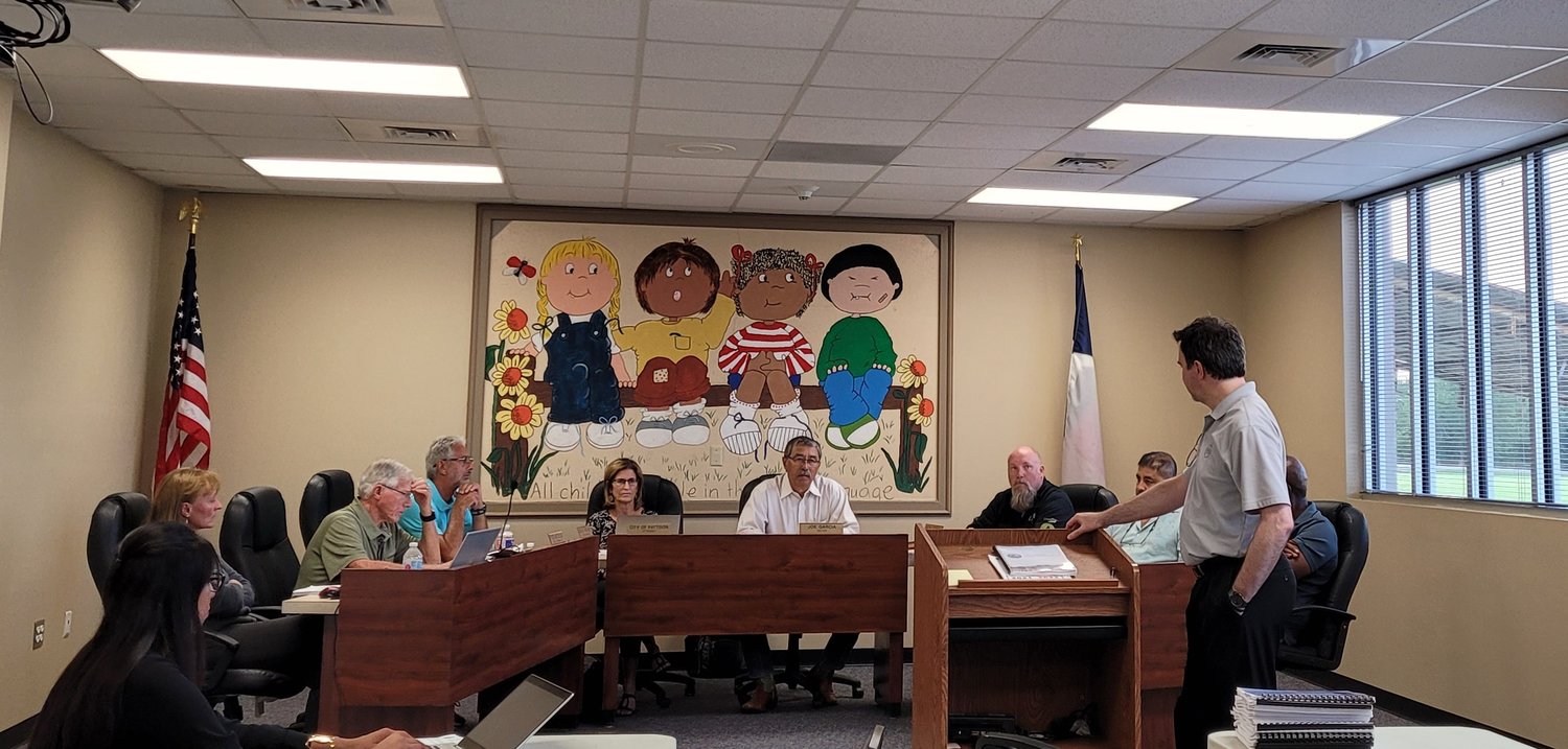 Chris Brown (at podium) addresses Pattison City Council during Tuesday evening’s meeting – the first in-person meeting for the city’s governing body since the pandemic forced them to go remote. Council met at the Royal ISD Administration Building, but may soon have their own council chambers to hold meetings in. Pictured from left to right: Deputy City Secretary Andrea Govea, City Secretary Lorene Hartfiel, Council Member Robert MacCallum, Council Member Wayne Kircher, City Attorney Lora Lenzsch, Mayor Joe Garcia, Council Member Seth Stokes, Council Member Frank Cobio, Jr. and Council Member Fred Branch (behind Brown).